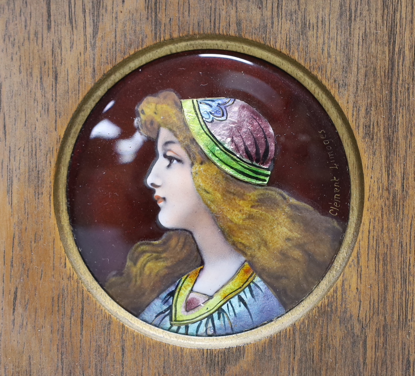 Clement Limoges: An Arts and Crafts enamelled circular plaque, of pre-Raphaelite girl, framed, plaque 5.5cm diameter